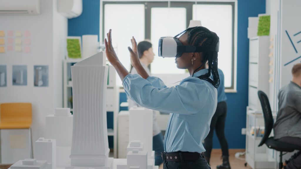 Close up of engineer working with vr glasses to plan building model and architectural layout