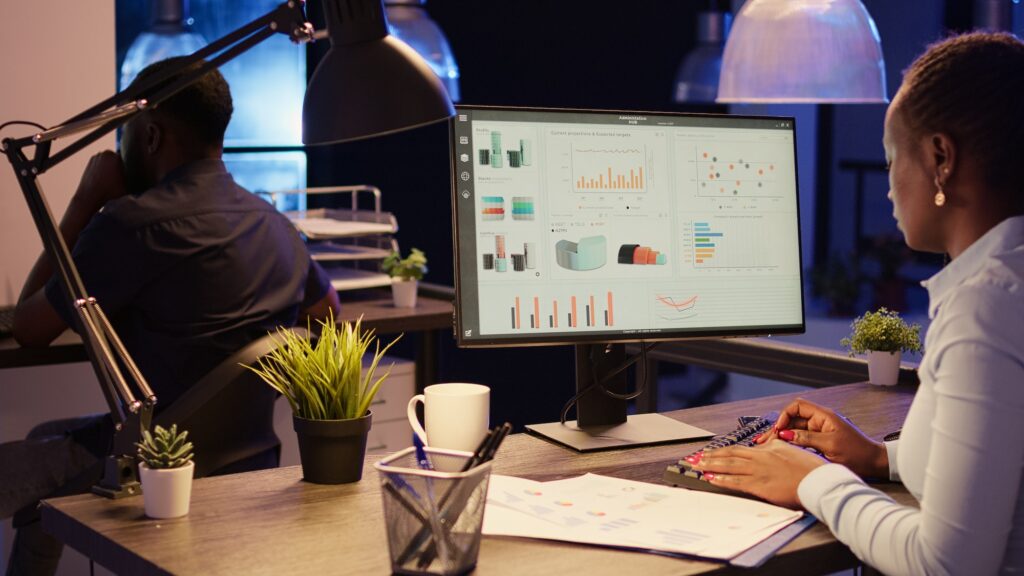 Office worker analyzing research data on computer network