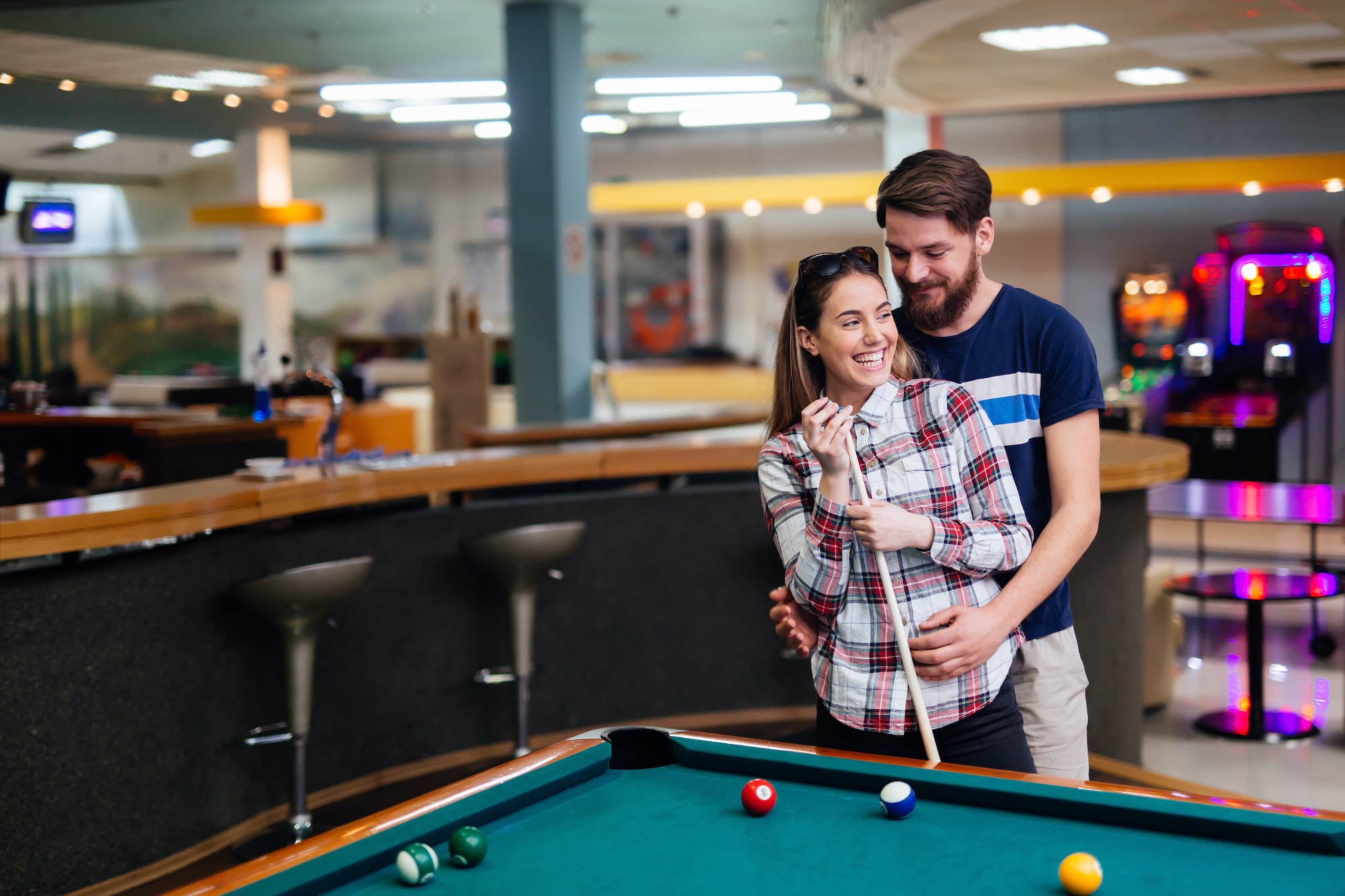 Beautiful couple playing billiards